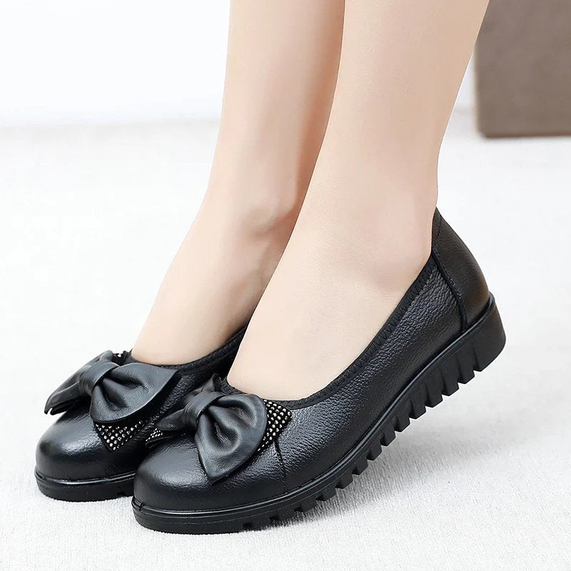 Brenda black bow flats worn, front view
